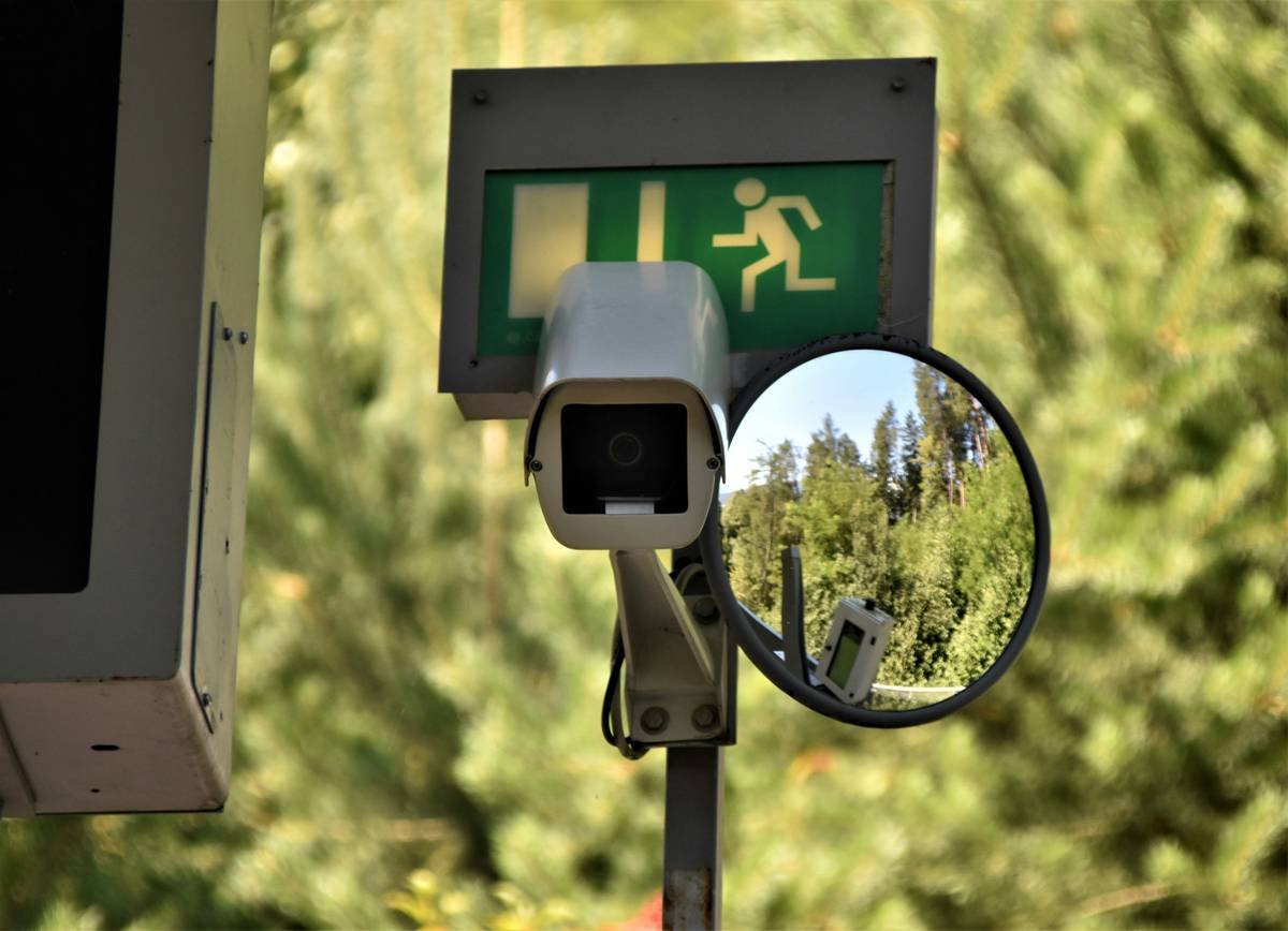 A webcam at a subway station with an emergency sign